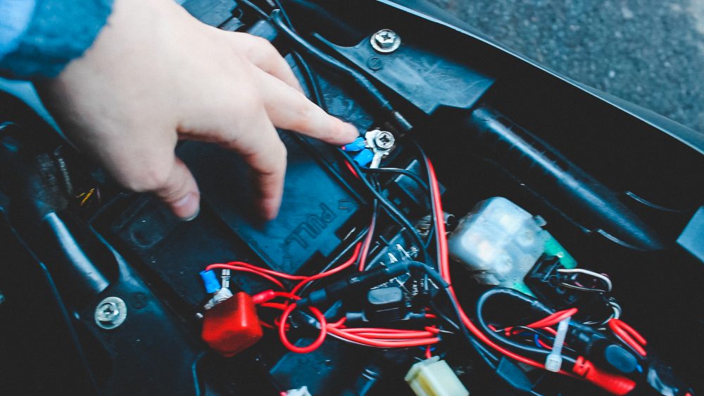 To install the tracker, simply pop your bike saddle off, find your motorcycle battery, loosen your battery bolts